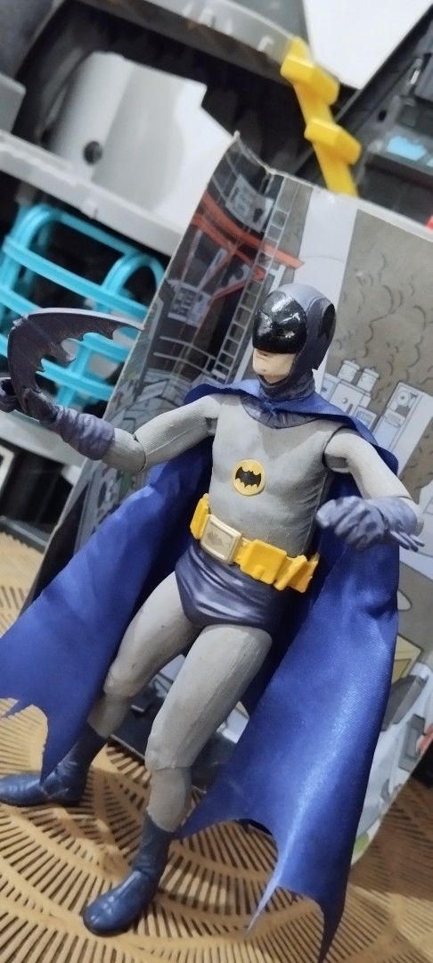 2015 NECA Batman: Adam West (Category: Figurines & Statues) located in Manila. Submitted by ventajetoyz625 (Listing ID 1469967748, Image 3). Description: - Authentic Batman action figure from the classic 1966 TV series line - 7 inches tall - Includes batarang accessory and themed display backdrop - Features articulation points in the arms, legs, and head for dynamic posing - Premium fabric cape for a realistic look - Comes in original packaging b