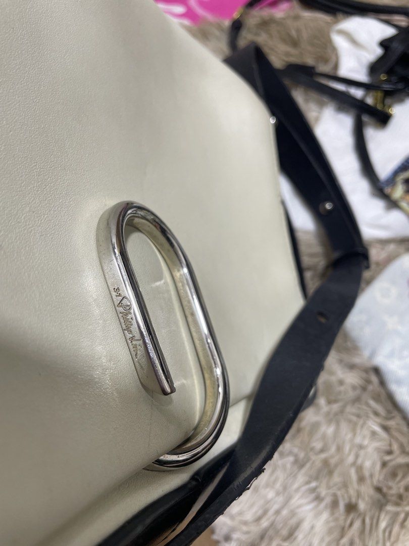 3.1 Phillip Lim White and Black Shoulder Bag (Category: Cross-body Bags) located in Santiago. Submitted by UkayLuxxSelector (Listing ID 1470090894, Image 3). Description: - Brand: 3.1 Phillip Lim - Color: White and black leather - Hardware: Silver-tone with front lock closure - Strap: Adjustable black strap on sides - Interior: White leather lining with a zipped pocket and gold-stamped logo - Shipping: Via J&T or LBC (Buyer bears shipping fee).