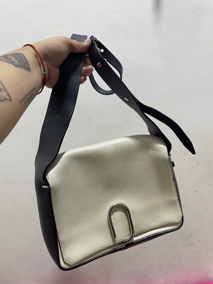 3.1 Phillip Lim White and Black Shoulder Bag (Category: Cross-body Bags) located in Santiago. Submitted by UkayLuxxSelector (Listing ID 1470090894, Image 2). Description: - Brand: 3.1 Phillip Lim - Color: White and black leather - Hardware: Silver-tone with front lock closure - Strap: Adjustable black strap on sides - Interior: White leather lining with a zipped pocket and gold-stamped logo - Shipping: Via J&T or LBC (Buyer bears shipping fee).
