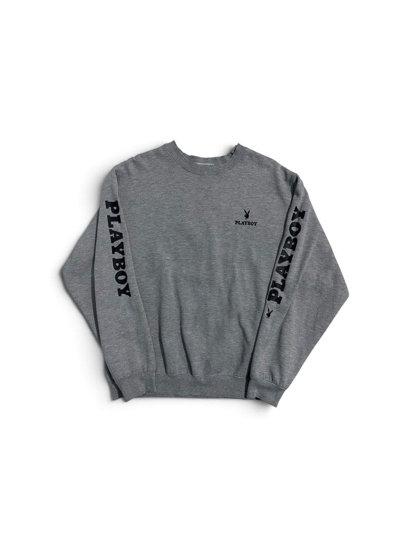 90s Playboy Grey Crewneck Sweatshirt (Category: Coats, Jackets and Outerwear) located in San Pablo. Submitted by gt_vault (Listing ID 1470124801, Image 1). Description: Ready to wear Width: Length: Color rate: 9/10 Condition: Excellent Issue: None - Size: XL - Color: Grey - Small embroidered Playboy logo on the chest - Bold black branding and tiny bunny graphics down both sleeves - Ribbed collar, cuffs, and hem - Thick fleece lining for extra war