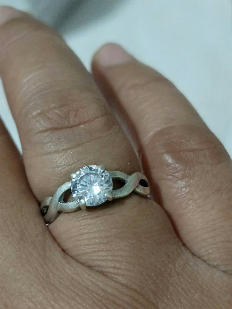 925 Silver Solitaire Ring with CZ Stone Size 5.5 (Category: Rings) located in Abucay. Submitted by thrifty.picked (Listing ID 1470120837, Image 3). Description: - Material: Solid 925 sterling silver (hallmarked on inner band) - Stone: Large round cubic zirconia with brilliant sparkle in a secure four-prong setting - Design: Elegant twisted crossover band - Size: Approximately size 5.5 on the mandrel - Condition: Clean metal and clear stone, ready
