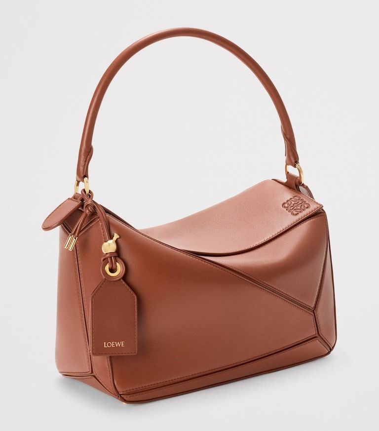 💜 LOEWE Medium Leather Featherlight Puzzle Top-Handle Bag (Category: Luxury Bags & Wallets) located in Lala. Submitted by mohsin0825 (Listing ID 1470034250, Image 1). Description: LOEWE Medium Leather Featherlight Puzzle Top-Handle Bag 17,990p pl7s sf Like new/ Brandnew shoulder or crossbody carry detachable and adjustable strap with rotating dogclips zip closure with articulated pull detachable LOEWE embossed tag with secret pocket and balloon 