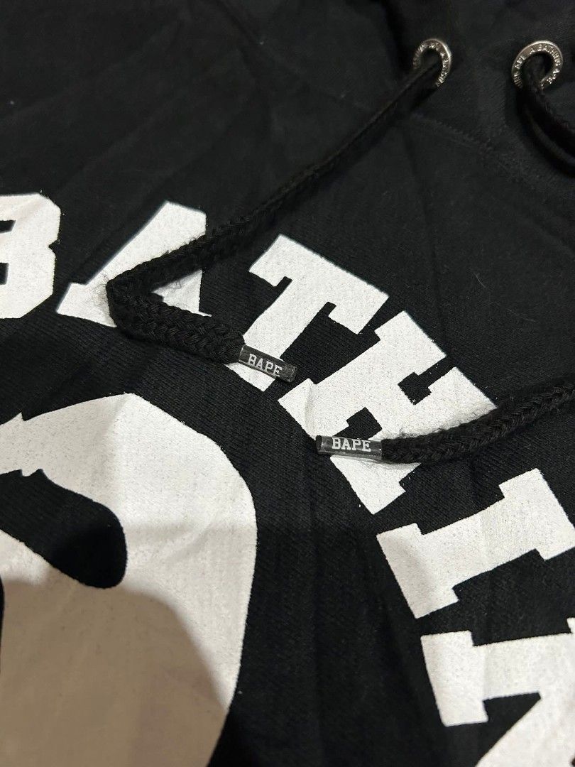 A Bathing Ape BAPE Black Arch Logo Hoodie (Category: Hoodies) located in Manila. Submitted by thegoodstuffs__ (Listing ID 1470139780, Image 3). Description: - Authentic Black BAPE Hoodie - Features iconic large white arch logo and ape head graphic on the front - Premium heavyweight cotton fleece for maximum comfort and warmth - Branded metal drawstrings tips and engraved eyelets - Classic sleeve tag near the cuff - Practical kangaroo pocket with 