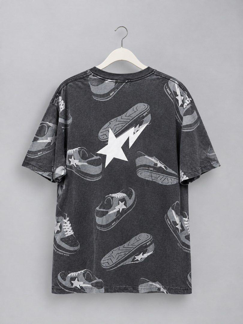 A Bathing Ape Bape Sneaker Print T-Shirt (Category: Tshirts & Polo Shirts ) located in Iloilo. Submitted by cloud.thrifts (Listing ID 1470062636, Image 2). Description: Bape tee in washed black colourway. Size large. All-over graphic print featuring Bape STA sneakers across the front and back. Big Bape logo lettering on the chest. Large white star graphic printed on the back. Crew neck style with branded interior neck taping. Cotton fabric with a