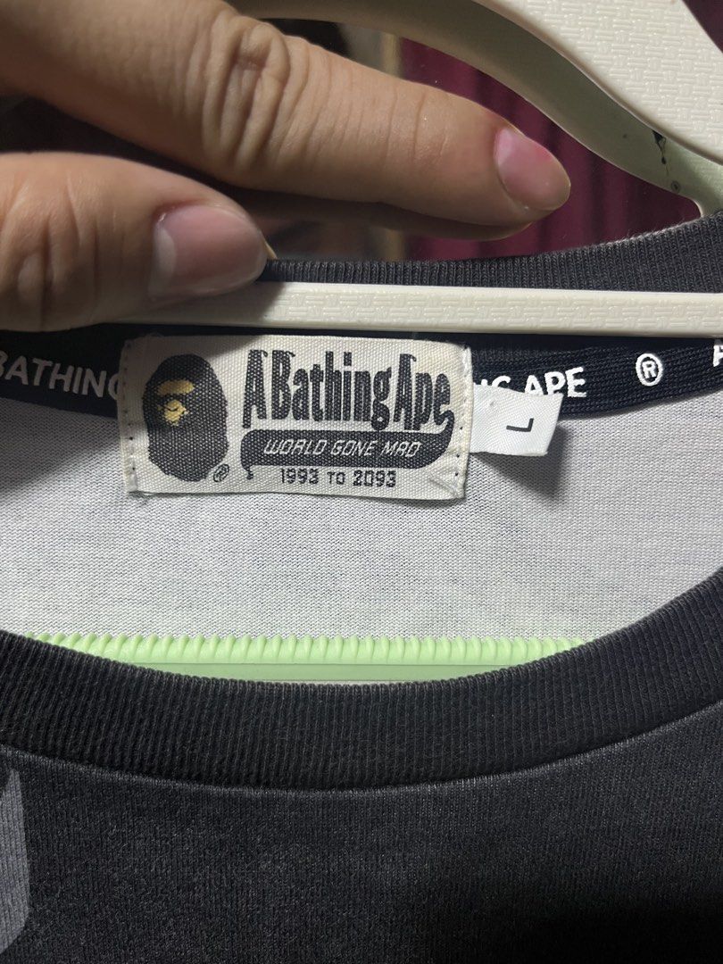 A Bathing Ape Bape Sneaker Print T-Shirt (Category: Tshirts & Polo Shirts ) located in Iloilo. Submitted by cloud.thrifts (Listing ID 1470062636, Image 3). Description: Bape tee in washed black colourway. Size large. All-over graphic print featuring Bape STA sneakers across the front and back. Big Bape logo lettering on the chest. Large white star graphic printed on the back. Crew neck style with branded interior neck taping. Cotton fabric with a