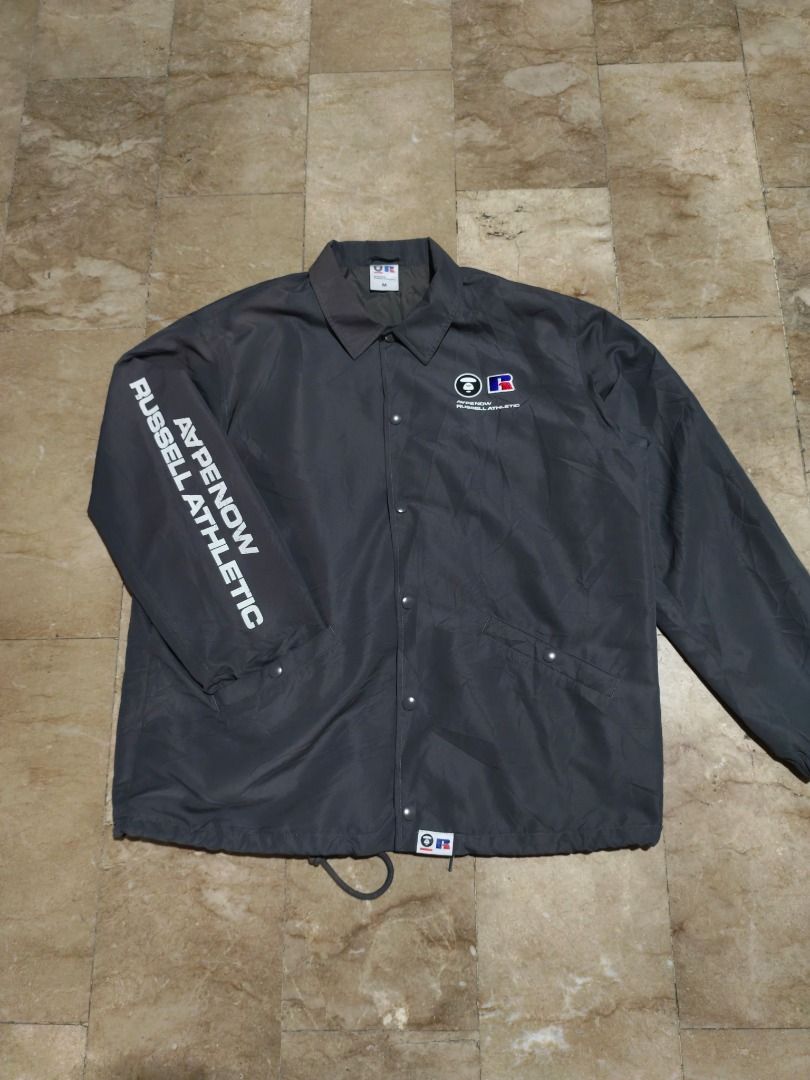 A Bathing Ape x Russell Athletic Coach Jacket (Category: Coats, Jackets and Outerwear) located in Santa Rosa. Submitted by izxenjairr80094 (Listing ID 1469999185, Image 1). Description: - Brand/Collab: Bape x Russell Athletic - Item: Dark grey nylon coach jacket - Size: Medium - Details: Dual brand logos on the chest, text graphic on the right sleeve - Closure & Fit: Snap button closure with an adjustable drawstring hem - Condition: Excellent - i
