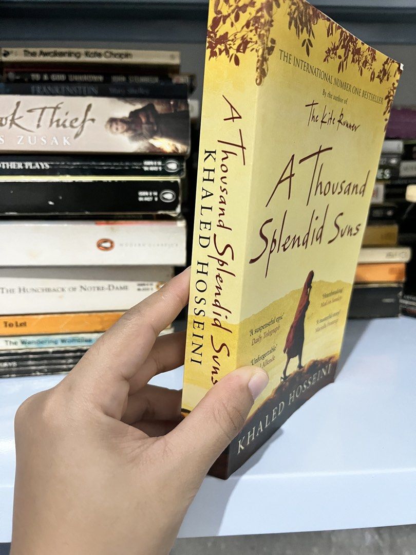 A Thousand Splendid Suns by Khaled Hosseini Paperback (Category: Storybooks) located in Maragondon. Submitted by quilljoylibrary (Listing ID 1469971530, Image 2). Description: - Title: A Thousand Splendid Suns by Khaled Hosseini - Format: Paperback - Genre: International bestseller / Moving drama set in Afghanistan - Condition: Readable copy with an intact spine; some pages show yellowing from age and storage - Perfect addition to your personal b