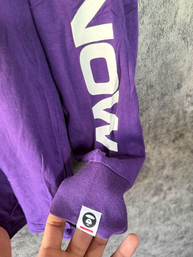 Aape Avenow Purple Long Sleeve Tee (Category: Tshirts & Polo Shirts ) located in Quezon City. Submitted by lexthrift (Listing ID 1469988428, Image 3). Description: - Brand: Aape by A Bathing Ape - Style: Purple long sleeve crewneck t-shirt - Size: Large (tag attached) - Details: Avenow text printed down both sleeves - Branding: Small Ape head logo patch on left chest and matching cuff tag - Condition: 100% authentic, well-maintained - Mode of Pay