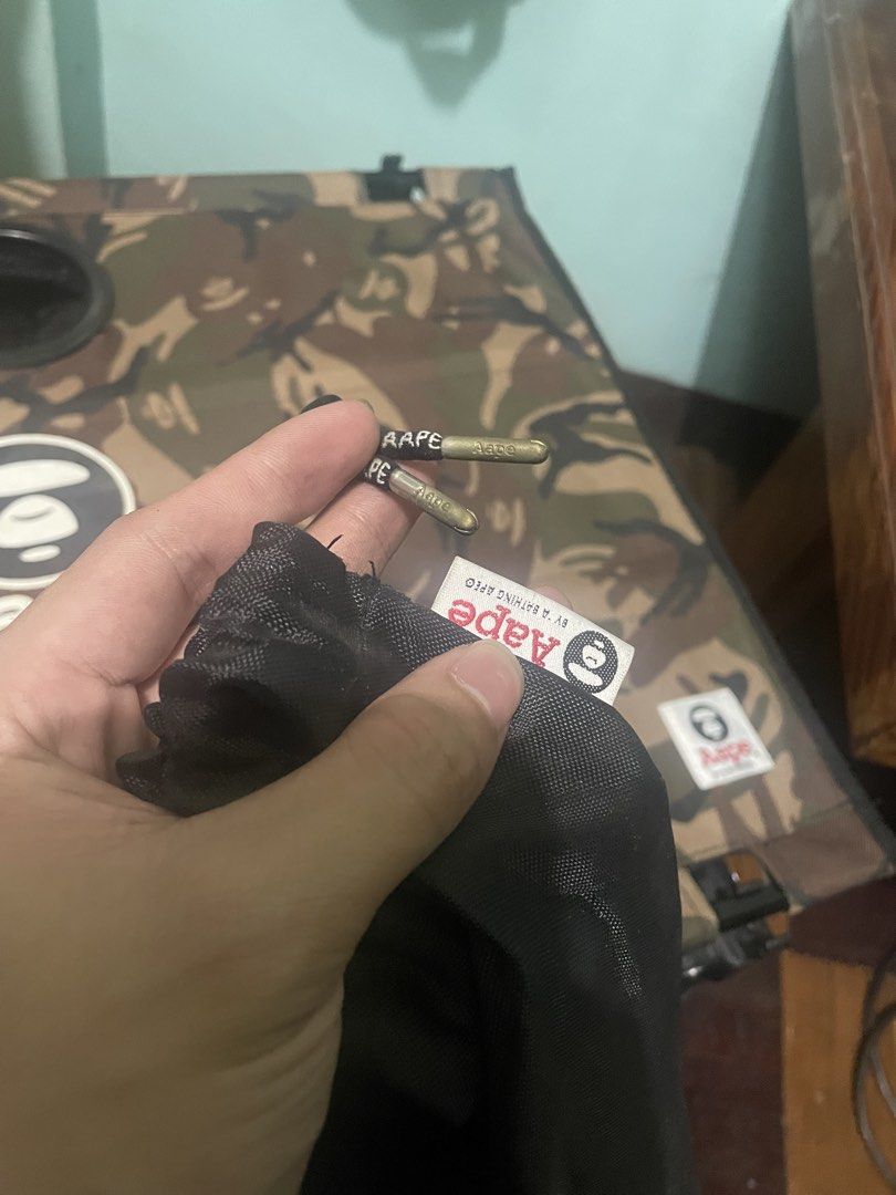 AAPE By A Bathing Ape Camo Folding Table (Category: Tables & Sets) located in Baguio. Submitted by claw_set (Listing ID 1470063624, Image 2). Description: - Authentic AAPE folding table featuring the signature camo print and bold brand logo - Built-in with 2 mesh cup holders for your drinks - Sturdy metal frame that folds down easily for quick storage and transport - Includes a black carrying bag with a branded strap and drawstring closure - Vers