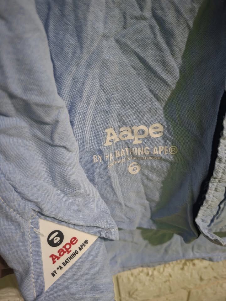Aape By Bathing Ape Polo Longsleeves (Category: Tshirts & Polo Shirts ) located in Bulacan. Submitted by bleue.finds (Listing ID 1470034682, Image 3). Description: Aape By Bathing Ape Polo Longsleeves 26.5 - front length 28 - back length 20.5 - width 24.5 - sleeve length minor issue : scratches on neck collar cut wash tags no other issues good condition .