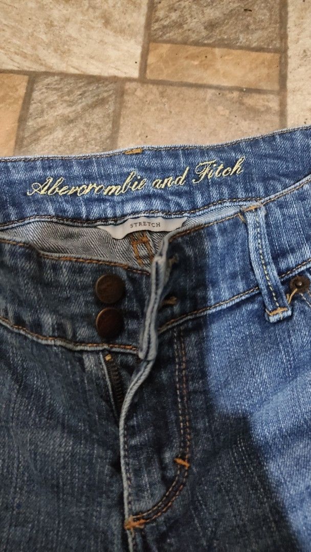 Abercrombie & Fitch Stretch Jeans Size 4 (Category: Jeans) located in Mangatarem. Submitted by itsumo_kokoro (Listing ID 1469979703, Image 3). Description: - Brand: Abercrombie & Fitch - Style: Stretch denim jeans in dark blue wash with slight thigh fading - Size: 4 - Closure: Two-button closure with zip fly - Pockets: Distinctive flapped back pockets with button closures and contrast stitching - Material: 98% cotton, 2% elastane for a comfortabl