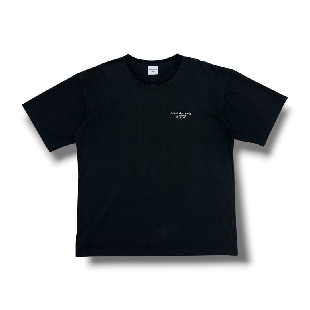 acmé de la vie ADLV Black T-Shirt (Category: Shirts) located in Quezon City. Submitted by grailph (Listing ID 1470064310, Image 2). Description: - Brand: acmé de la vie (ADLV) - Color: Black with white typography - Size: 2 - Dimensions: 24”x29” - Design: Small front chest logo, large graphic print across back shoulders - Fit: Standard crew neck, short sleeves - Material: Solid cotton fabric - Style: Classic streetwear, highly versatile for casual