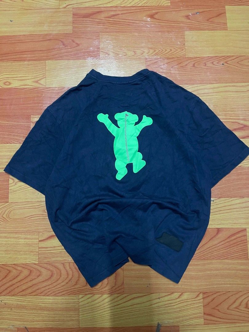 Ader Error Blue T-Shirt With Green Graphic (Category: Tshirts & Polo Shirts ) located in Ozamiz City. Submitted by tripft.vonde (Listing ID 1470048682, Image 3). Description: - Color: Dark blue with vibrant green contrast prints - Design: Front bear with brown details and logo; back bear with a center zipper design - Branding: Small black rubber patch with embossed logo near the hem - Fit & Feel: Casual streetwear fit made from soft, comfortable 