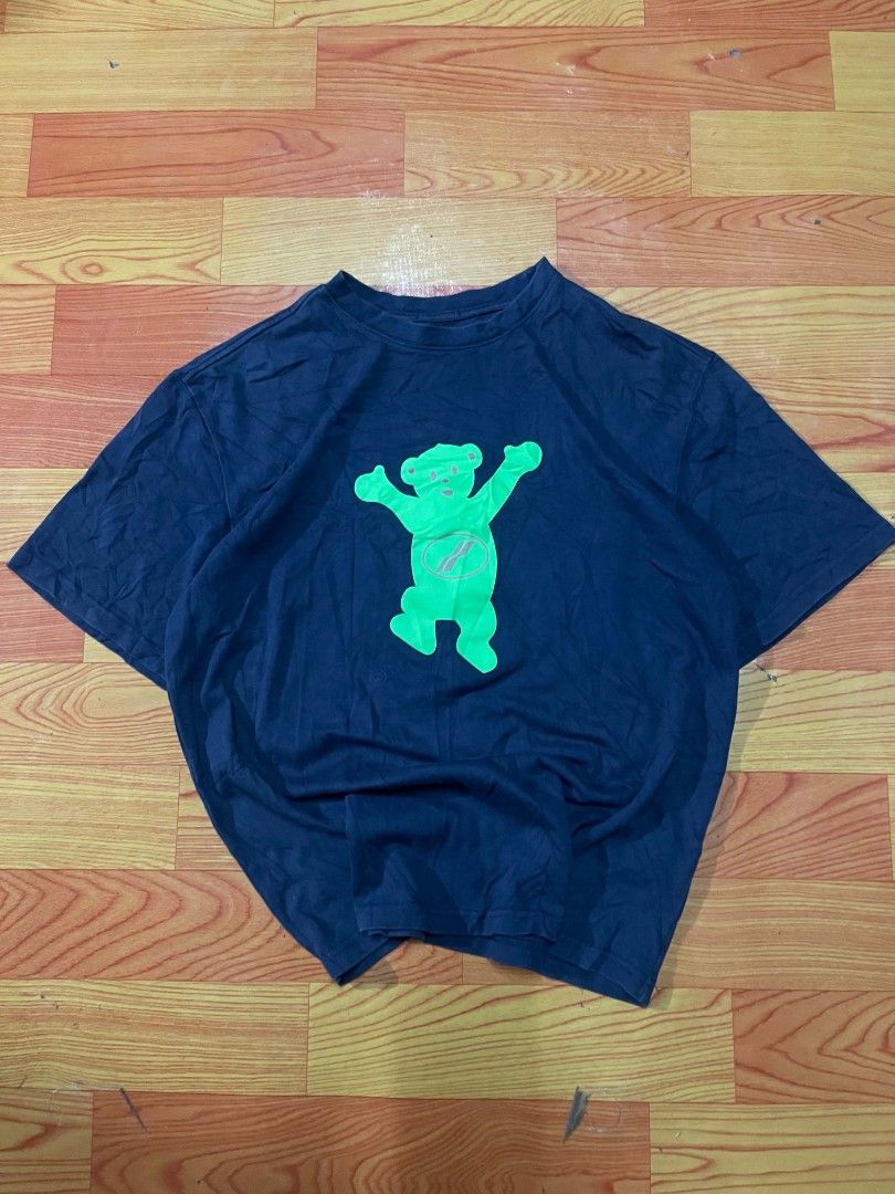 Ader Error Blue T-Shirt With Green Graphic (Category: Tshirts & Polo Shirts ) located in Ozamiz City. Submitted by tripft.vonde (Listing ID 1470048682, Image 1). Description: - Color: Dark blue with vibrant green contrast prints - Design: Front bear with brown details and logo; back bear with a center zipper design - Branding: Small black rubber patch with embossed logo near the hem - Fit & Feel: Casual streetwear fit made from soft, comfortable 