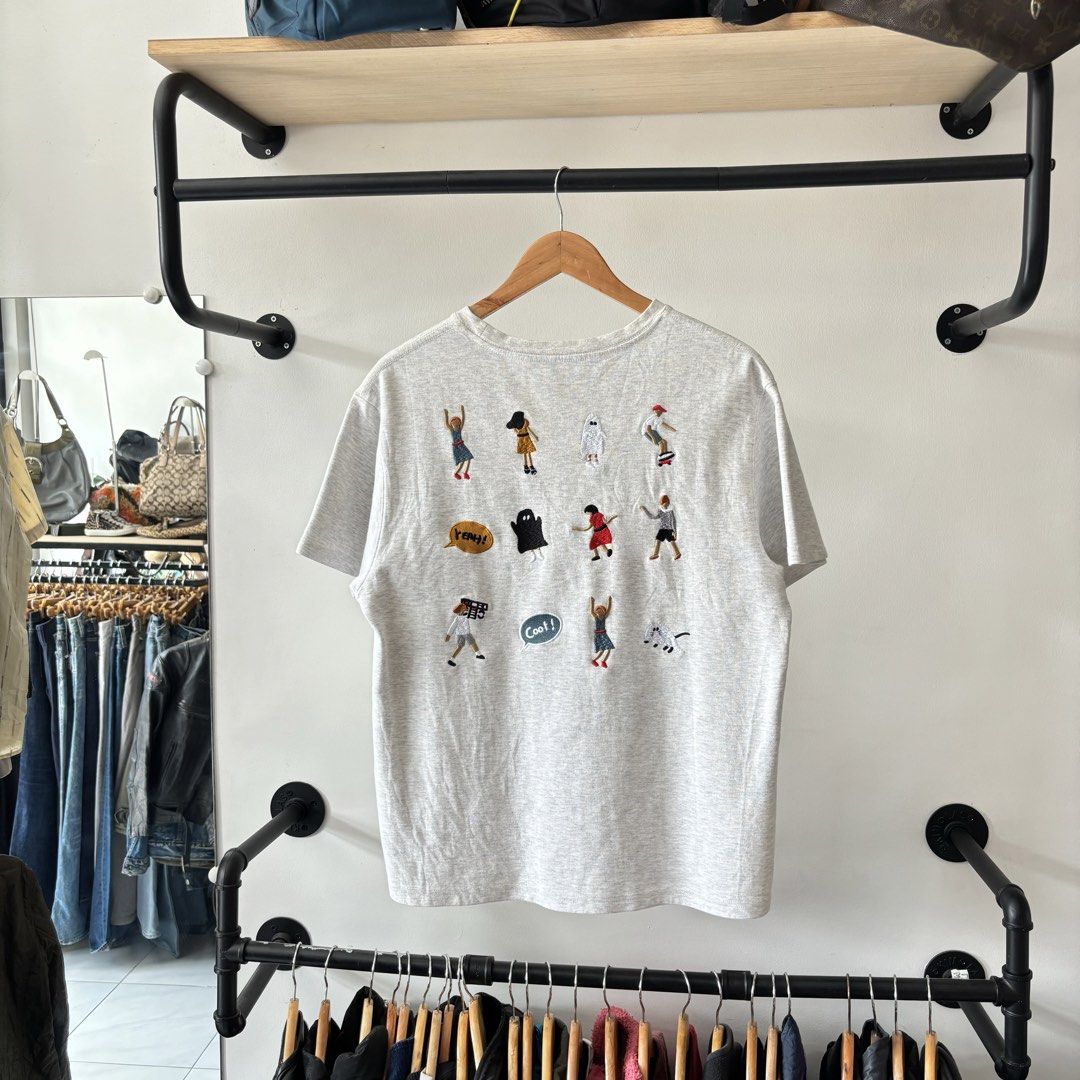 Ader Error Grey Graphic Back Print T-shirt Size A2 (Category: Tshirts & Polo Shirts ) located in Bambang. Submitted by heats777 (Listing ID 1470018761, Image 3). Description: - Brand: Ader Error - Collection: SS21 - Color: Grey - Size: A2 - Material: Soft cotton for a comfortable fit - Design: Classic crew neck with front embroidered speech bubble logo - Back Details: Heavy graphic patch design featuring multiple detailed embroidered figures and 