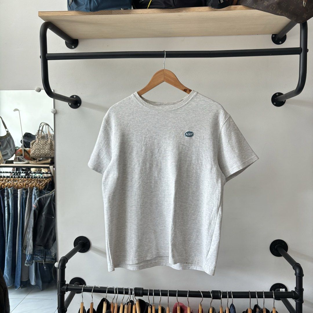 Ader Error Grey Graphic Back Print T-shirt Size A2 (Category: Tshirts & Polo Shirts ) located in Bambang. Submitted by heats777 (Listing ID 1470018761, Image 2). Description: - Brand: Ader Error - Collection: SS21 - Color: Grey - Size: A2 - Material: Soft cotton for a comfortable fit - Design: Classic crew neck with front embroidered speech bubble logo - Back Details: Heavy graphic patch design featuring multiple detailed embroidered figures and 