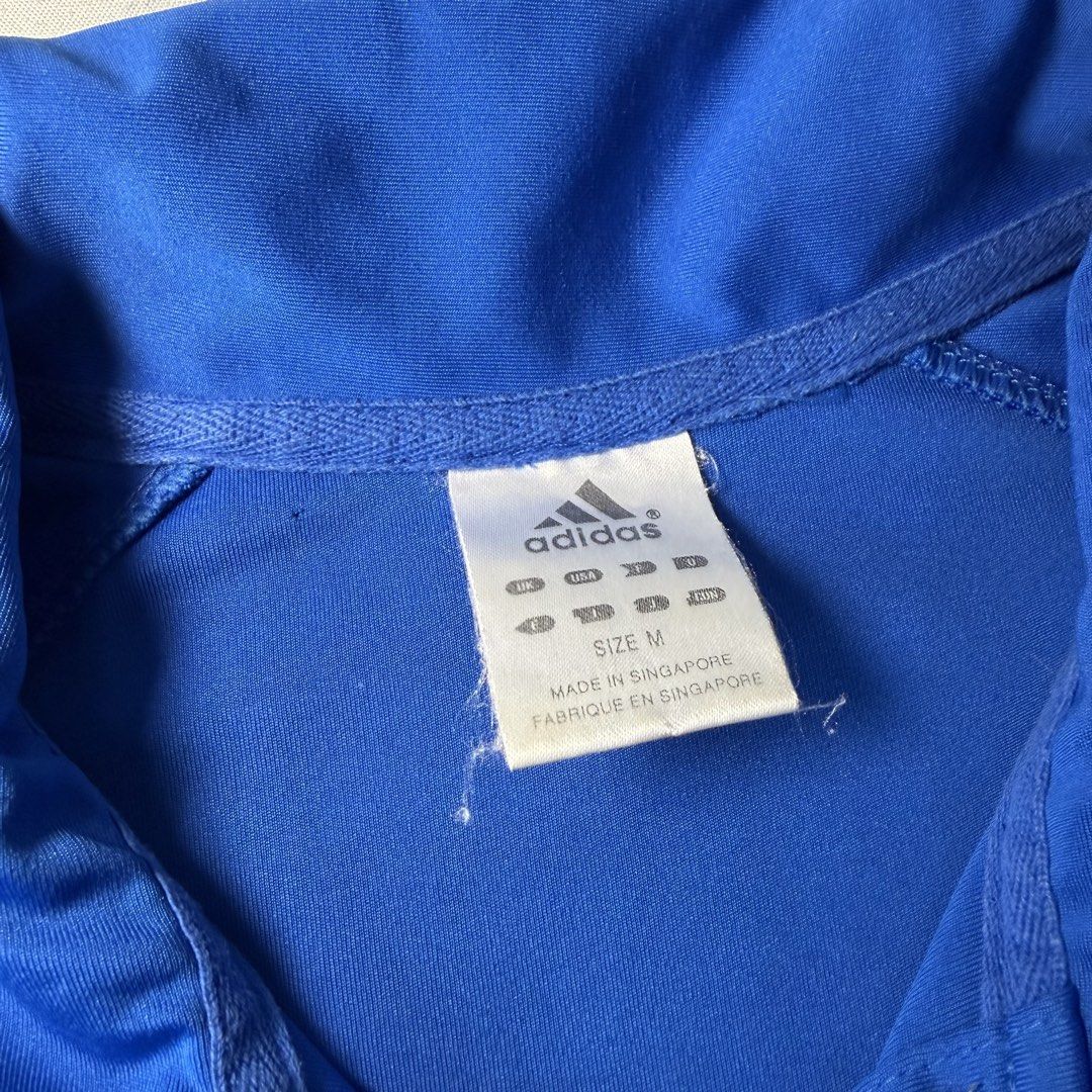 Adidas Blue Polo Shirt Size M (Category: Tshirts & Polo Shirts ) located in Manila. Submitted by jxuerae (Listing ID 1470125506, Image 3). Description: - Brand: Adidas - Color: Bright blue with dark accents on sleeves and collar - Size: Medium (Regular fit) - Details: Three-button placket with one branded button, embroidered Adidas logo on chest - Origin: Made in Singapore - Condition: Excellent Color may vary due to lighting. Dm me for dimes Pre