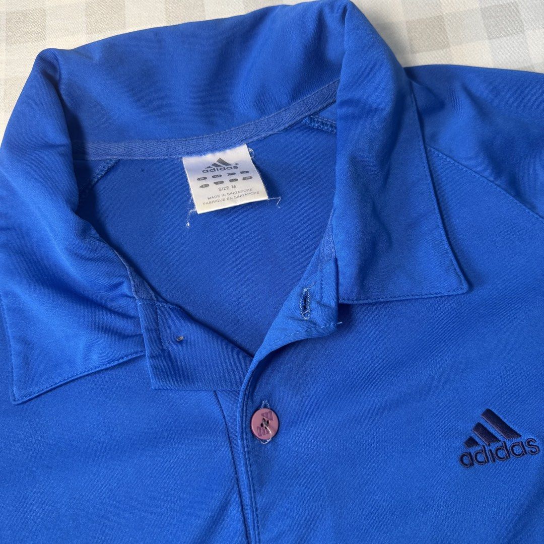 Adidas Blue Polo Shirt Size M (Category: Tshirts & Polo Shirts ) located in Manila. Submitted by jxuerae (Listing ID 1470125506, Image 2). Description: - Brand: Adidas - Color: Bright blue with dark accents on sleeves and collar - Size: Medium (Regular fit) - Details: Three-button placket with one branded button, embroidered Adidas logo on chest - Origin: Made in Singapore - Condition: Excellent Color may vary due to lighting. Dm me for dimes Pre