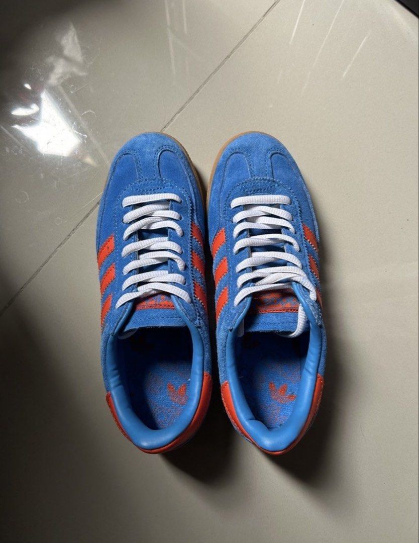 Adidas Handball Spezial Blue Orange (Category: Sneakers) located in Quezon City. Submitted by jamsweetjam (Listing ID 1470039220, Image 2). Description: - Style: Retro indoor trainer - Colorway: Bright blue suede with vibrant orange stripes - Soles: Classic gum soles with clean textured treads - Details: Metallic gold branding on the side, neat white laces - Comfort: Comfortable fit, ideal for daily casual wear.