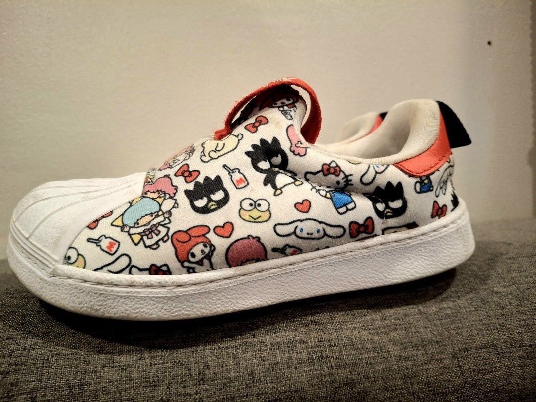 Adidas Hello Kitty X Superstar 360 (Category: Sneakers) located in Manila. Submitted by jilliese (Listing ID 1469965261, Image 3). Description: Branded Preloved Like new Size : 24 17cm- insole 19cm-outsole No box natapon ko na po Pickup//deliver Loc: Baesa Caloocan - Brand: Adidas Superstar 360 x Kitty and Friends - Style: Slip-on kids shoes with iconic shell toe design - Color: White with playful red accents - Size: 24 - Condition: Worn a few ti