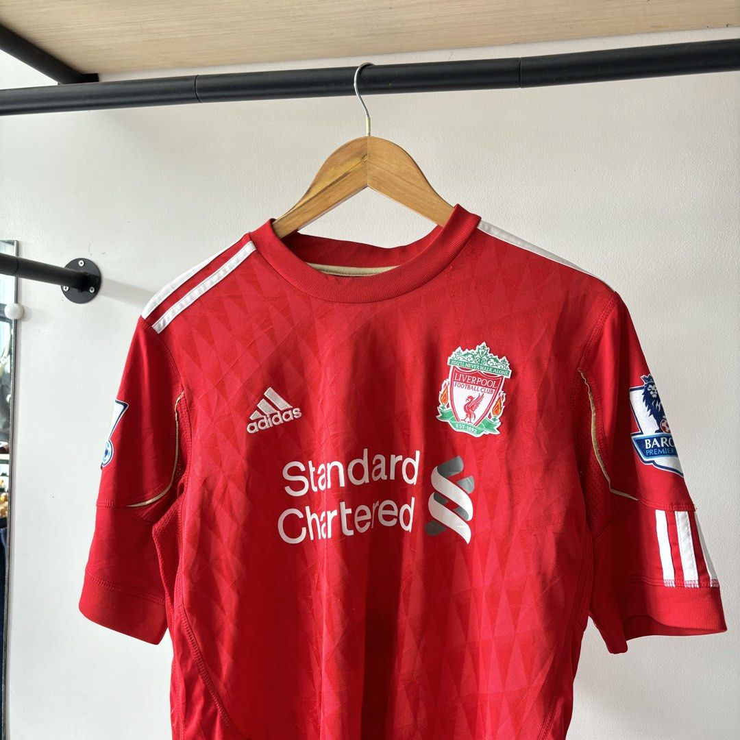 Adidas Liverpool Suarez 7 Home Jersey Medium (Category: Activewear) located in Bambang. Submitted by heats777 (Listing ID 1470018802, Image 1). Description: - Authentic Liverpool home jersey from the legendary Adidas era - Features Suarez name and number 7 printing on the back - Standard Chartered sponsor on the front with Premier League patches on both sleeves - Crafted with breathable ClimaCool fabric - Size: Medium (M) - Classic red design acc