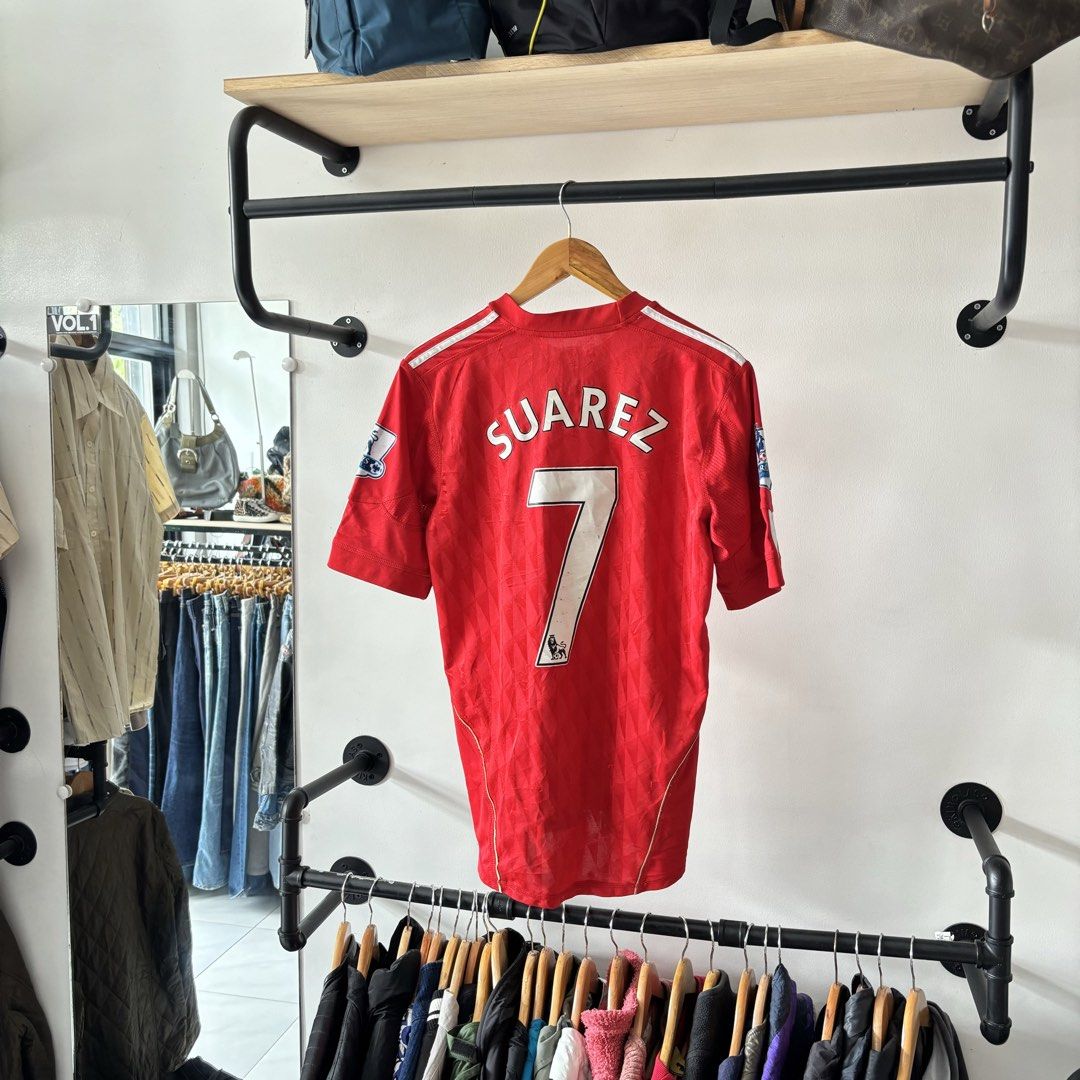Adidas Liverpool Suarez 7 Home Jersey Medium (Category: Activewear) located in Bambang. Submitted by heats777 (Listing ID 1470018802, Image 3). Description: - Authentic Liverpool home jersey from the legendary Adidas era - Features Suarez name and number 7 printing on the back - Standard Chartered sponsor on the front with Premier League patches on both sleeves - Crafted with breathable ClimaCool fabric - Size: Medium (M) - Classic red design acc