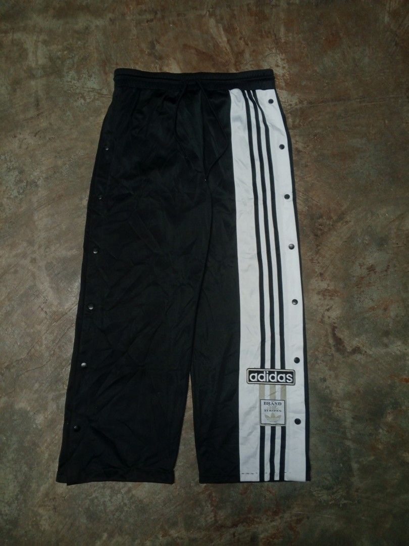 Adidas Snap Track Pants Black White Size L (Category: Joggers) located in Manila. Submitted by heavenlyclo05 (Listing ID 1470001258, Image 1). Description: ADIDAS BAGGY TRACKPANT Size: Large Width: 34 - 40 Length: 39 Hem: 10 Very Good Condition issue: ALTERED - Brand: Adidas - Color: Black and White - Style: Wide leg with full snap buttons down the sides - Details: Large Adidas logo badge on the left leg - Waistband: Drawstring elastic waist for 
