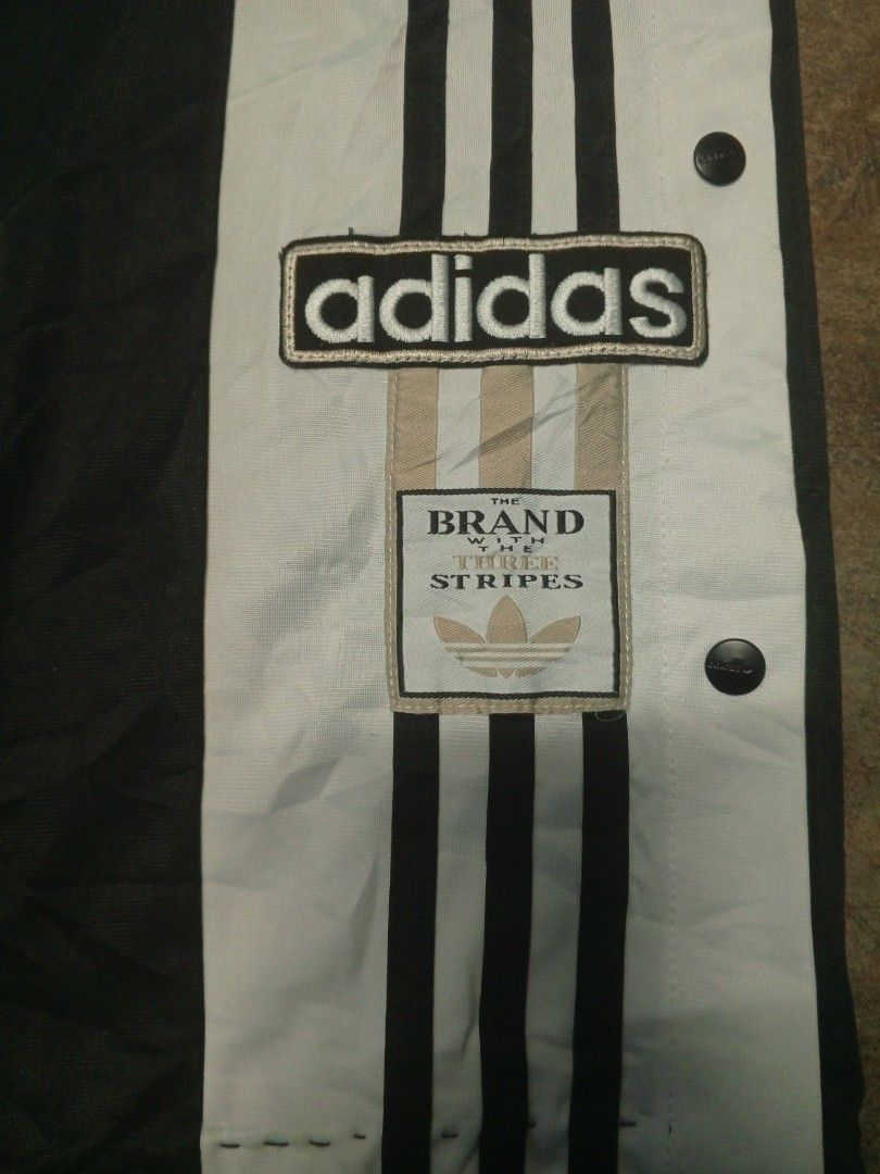 Adidas Snap Track Pants Black White Size L (Category: Joggers) located in Manila. Submitted by heavenlyclo05 (Listing ID 1470001258, Image 2). Description: ADIDAS BAGGY TRACKPANT Size: Large Width: 34 - 40 Length: 39 Hem: 10 Very Good Condition issue: ALTERED - Brand: Adidas - Color: Black and White - Style: Wide leg with full snap buttons down the sides - Details: Large Adidas logo badge on the left leg - Waistband: Drawstring elastic waist for 