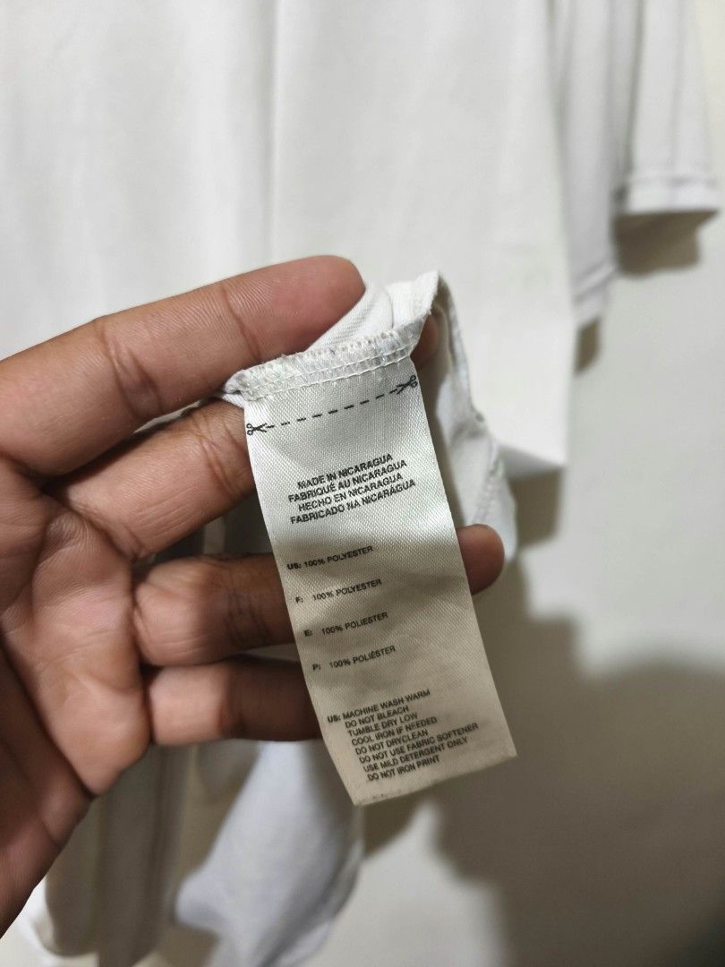Adidas White Polyester T-Shirt (Category: Shirts) located in Caloocan City. Submitted by Tulokss (Listing ID 1470114457, Image 3). Description: - Brand: Adidas - Material: 100% polyester (lightweight and breathable) - Color: White - Details: Short sleeves, crew neck, small printed logo on the chest - Origin: Made in Nicaragua - Condition: Good for casual wear or workouts, but please note there are noticeable stains near the chest area and on the 