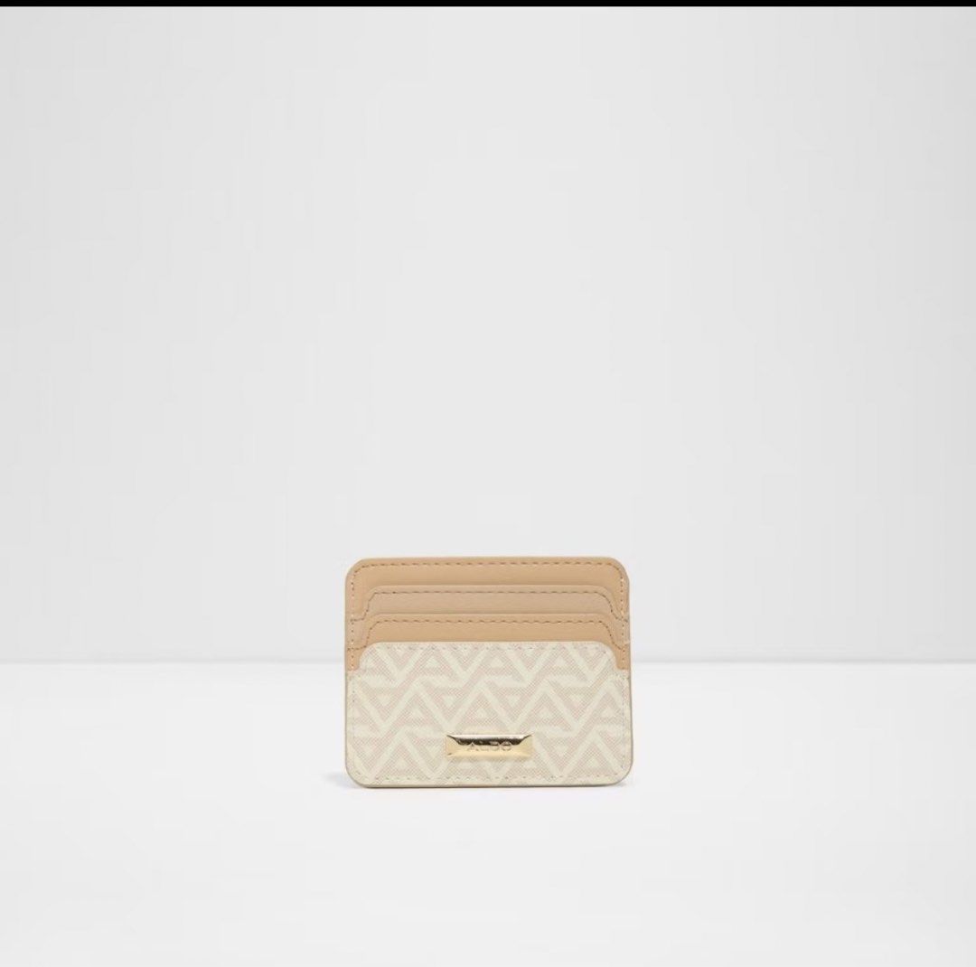 ALDO beige and cream patterned card holder (Category: Wallets & Card holders) located in Manila. Submitted by pureocean.ab9765 (Listing ID 1469977443, Image 1). Description: - Brand: ALDO - Design: Beige and cream geometric pattern with gold-tone hardware and logo plaque - Storage: Multiple card slots on front and back - Size: Compact, easily fits in small bags or pockets - Style: Neutral tones that match any everyday carry.