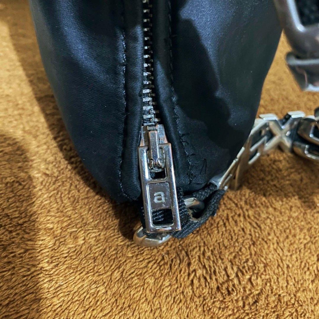 Alexander Wang Black Nylon Heiress Shoulder Bag (Category: Luxury Bags & Wallets) located in Manila. Submitted by jiiiiiiiiiims (Listing ID 1470071799, Image 3). Description: - Brand: Alexander Wang New York - Material: Durable black nylon with European leather details - Hardware: Silver-tone throughout with branded zippers - Standout Feature: Chunky metal letters strap spelling out the brand name - Interior: Clean lining with leather brand patch