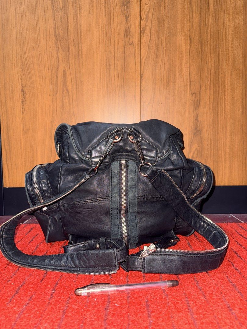 Alexander Wang-Style Marti Multi-Zip Backpack – Black (Category: Backpacks) located in Davao. Submitted by rebaggedph (Listing ID 1469989429, Image 2). Description: Edgy, statement-making black backpack with the signature multi-zipper look inspired by Alexander Wang’s Marti design. A versatile piece for everyday wear, travel, or street-style outfits. Features * Black leather-like exterior with contrasting grey-green suede-like trim * Multiple sil