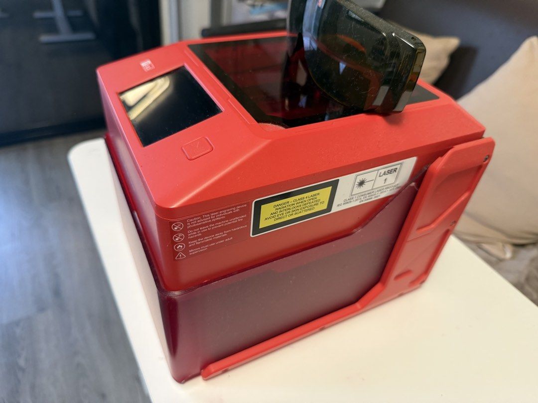 AlgoLaser PIXI Portable Mini Laser Cutter & Engraver (Category: Printers, Scanners & Copiers) located in Caloocan City. Submitted by honey114 (Listing ID 1469955559, Image 2). Description: - Model: AlgoLaser PIXI Laser Engraving Machine in striking red - Materials: Easily handles wood, metal, and acrylic carving projects - Interface: Built-in touch screen on the top panel for simple operation - Safety: Includes a protective dark tinted enclosure 
