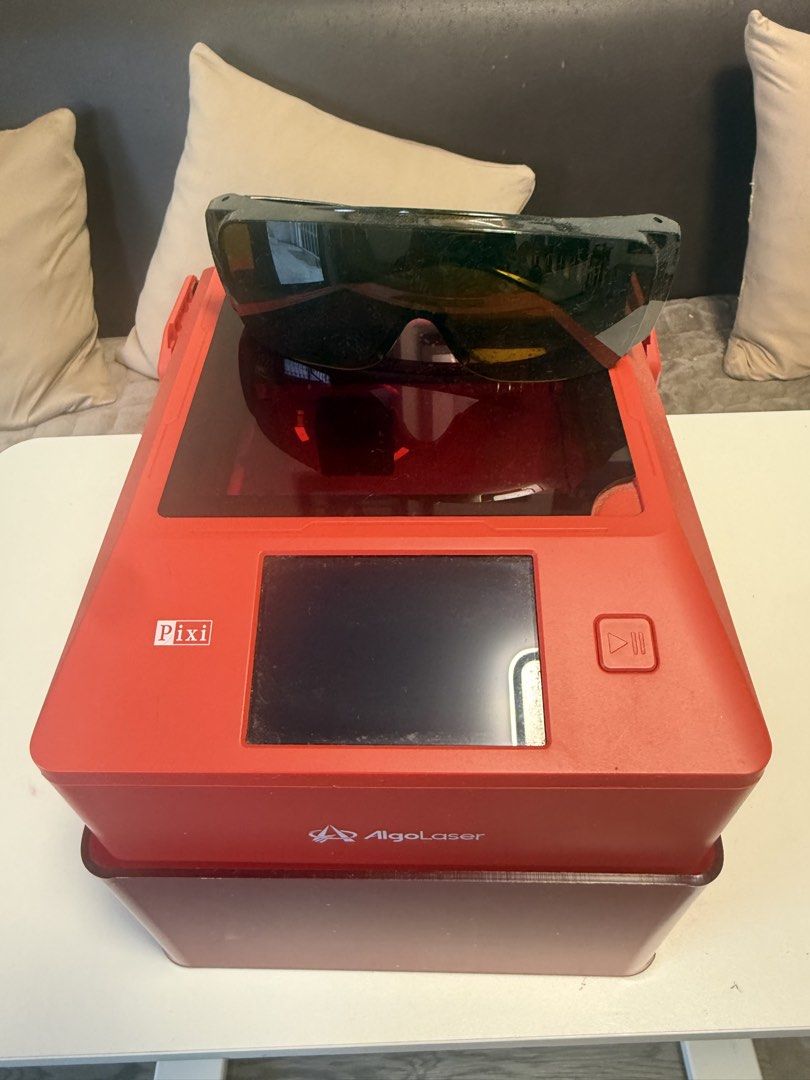 AlgoLaser PIXI Portable Mini Laser Cutter & Engraver (Category: Printers, Scanners & Copiers) located in Caloocan City. Submitted by honey114 (Listing ID 1469955559, Image 3). Description: - Model: AlgoLaser PIXI Laser Engraving Machine in striking red - Materials: Easily handles wood, metal, and acrylic carving projects - Interface: Built-in touch screen on the top panel for simple operation - Safety: Includes a protective dark tinted enclosure 