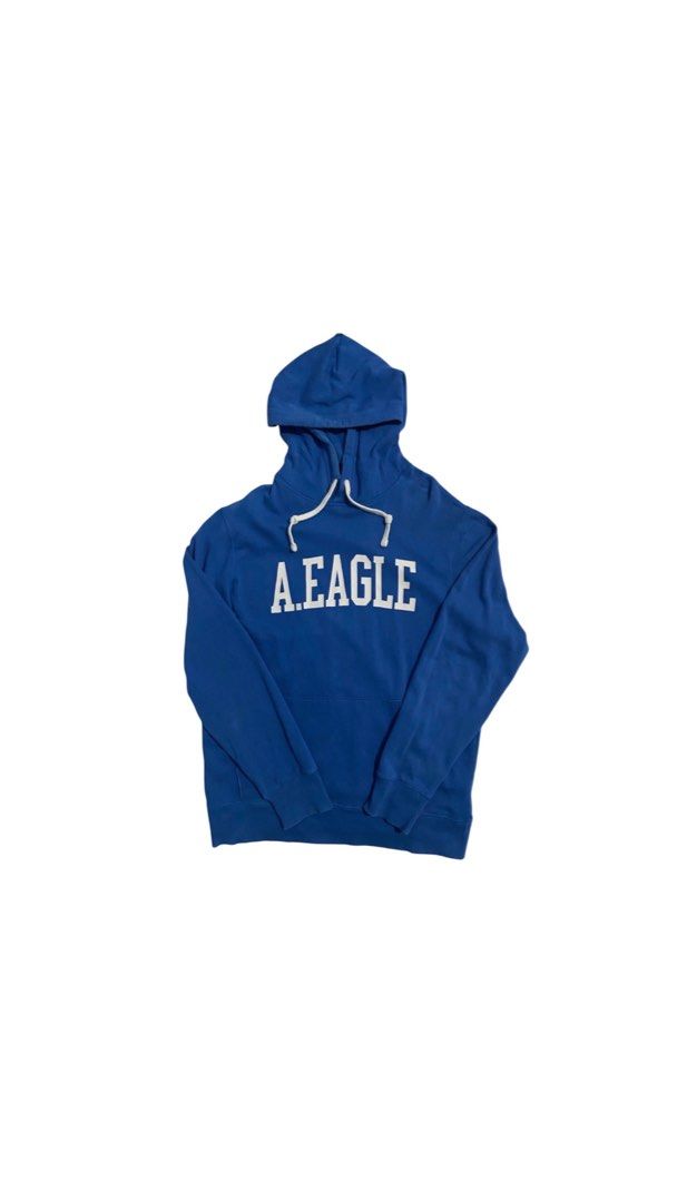 American Eagle Blue a.eagle Hoodie (Category: Coats, Jackets and Outerwear) located in San Pablo. Submitted by gt_vault (Listing ID 1470124099, Image 1). Description: Ready to wear Width: Length: Color rate: 8.5/10 Condition: Good Issue: None - Brand/Style: Authentic American Eagle hoodie in a vibrant blue color - Size: Medium with a comfortable classic fit - Design: Bold white A.EAGLE text graphic printed across the chest - Features: Adjustable 