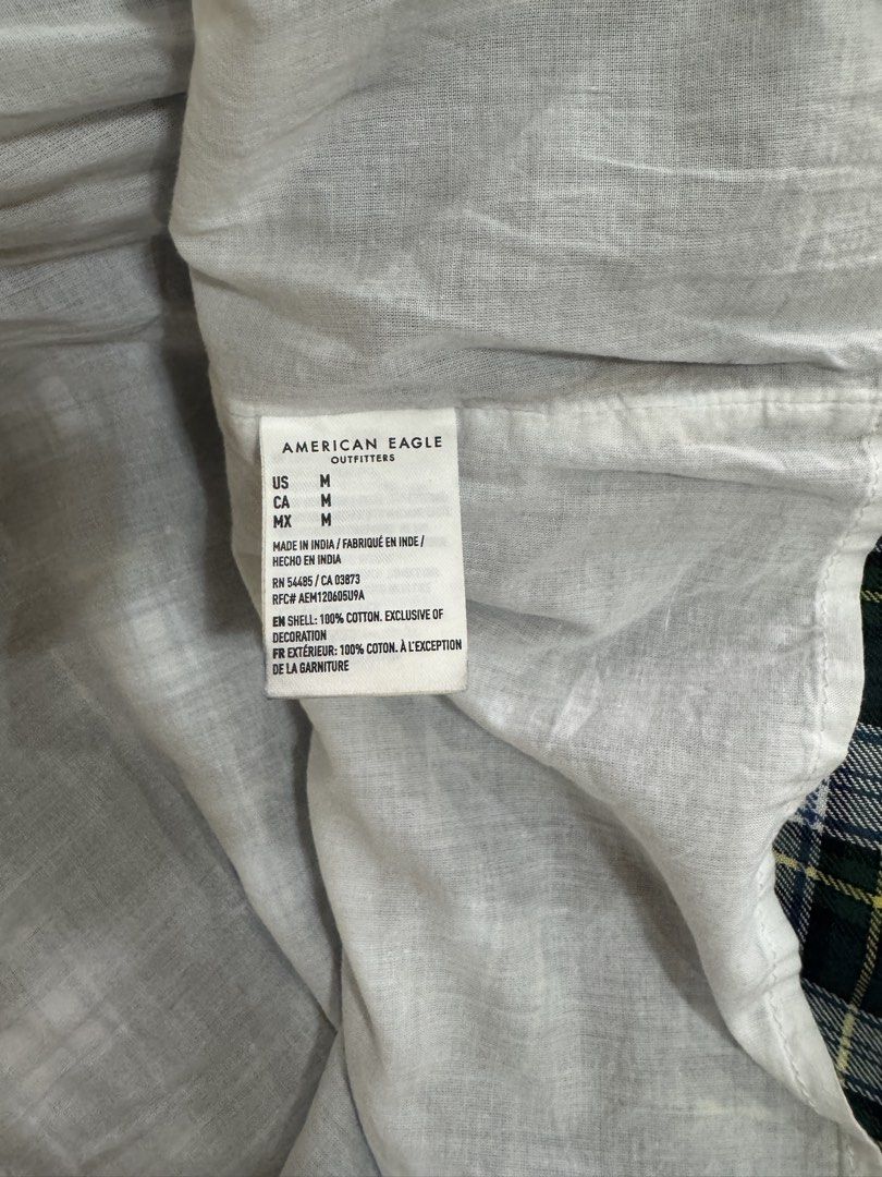 American Eagle Plaid Smocked Dress Size M (Category: Dresses) located in Dagupan City. Submitted by truehawk.c51029 (Listing ID 1470090065, Image 3). Description: - Brand: American Eagle - Size: Medium - Color/Pattern: Green, white, and black plaid - Design: Short puff sleeves, square neckline - Style: Comfortable and perfect for casual everyday wear.
