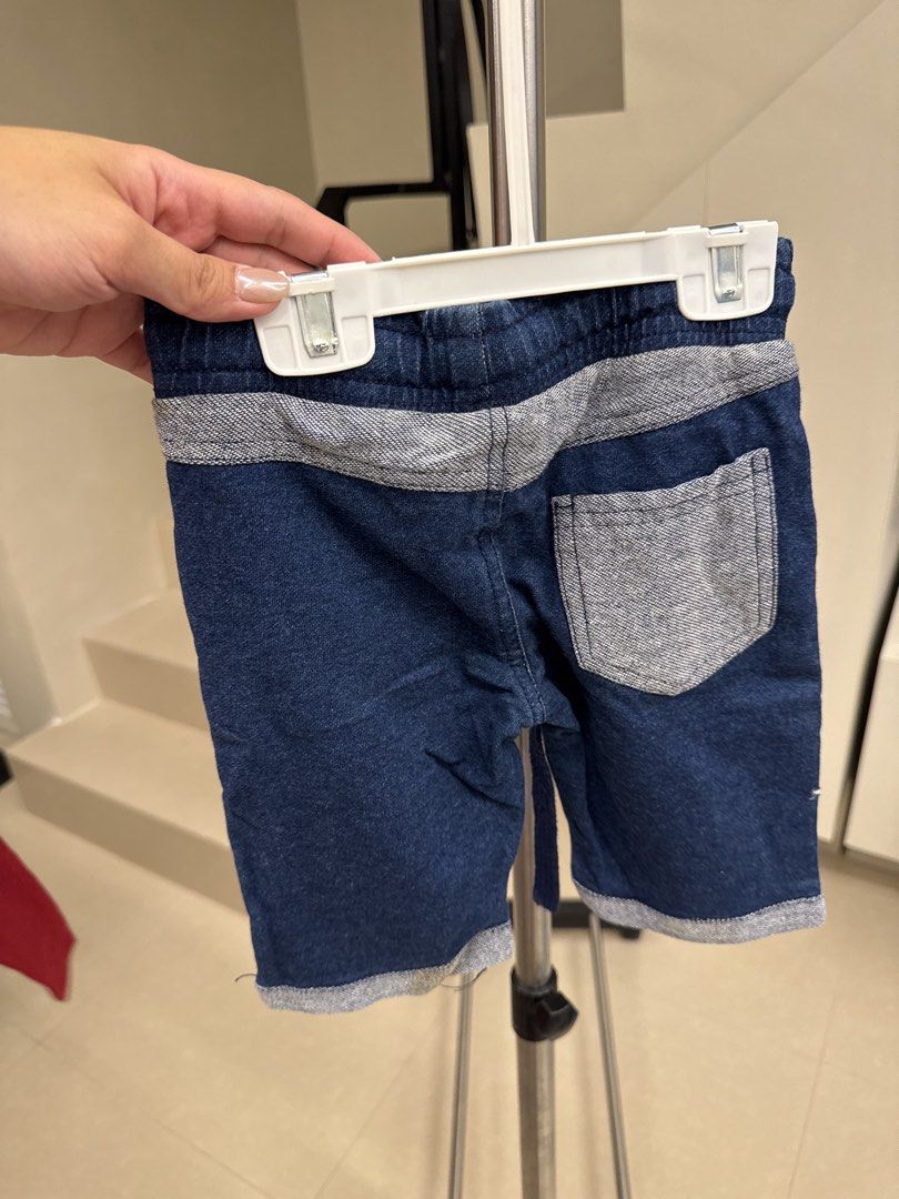 American Raw Denim Shorts Size 4 (Category: Babies & Kids Fashion) located in Manila. Submitted by __nix (Listing ID 1470018099, Image 2). Description: - Size: 4 - Material: 100% cotton raw denim - Color: Dark blue with grey contrast panels on sides, back yoke, and pocket - Waistband: Elastic with adjustable drawstring - Hem: Rolled cuffs - Style: Casual, perfect for everyday wear.