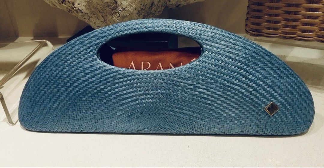 Arañaz Amour 2 (NEW) (Category: Clutches) located in Quezon City. Submitted by purplemoshi (Listing ID 1470041362, Image 1). Description: ARAÑAZ Amor 2 Mini in Blue RFS: not being used (original price 7,500) Complete inclusions. Paperbag, wrappings and dust bag - Color & Material: Blue woven straw with a unique textured pattern - Design: Semi-circle shape with a convenient integrated top cutout handle - Details: Features a small metallic logo emb