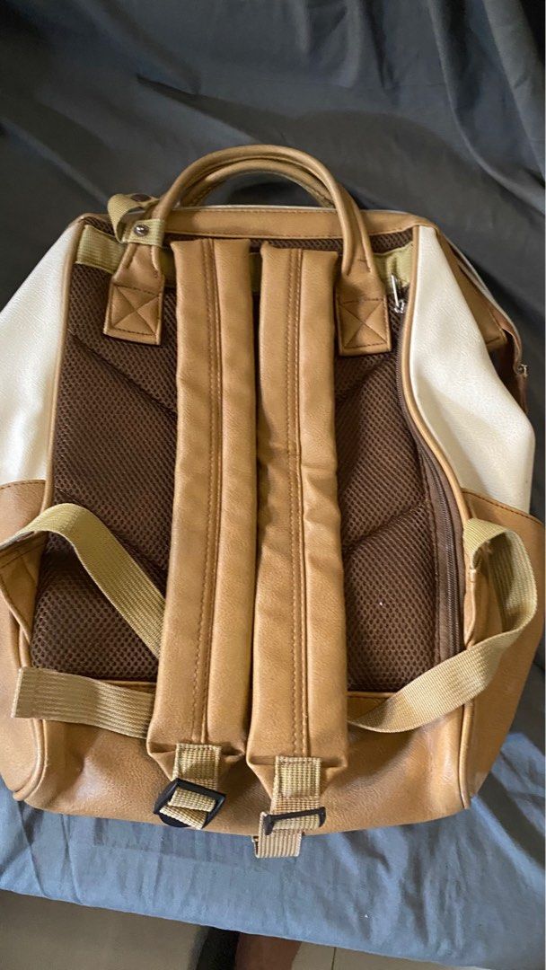anello Two-Tone Faux Leather Backpack (Category: Backpacks) located in San Isidro. Submitted by miradelacruz1612 (Listing ID 1469963278, Image 2). Description: - Color: Stylish tan and cream combination - Material: Premium faux leather - Design: Wide-opening main compartment with a structured frame - Storage: Convenient front zipper pocket with pull tab - Comfort: Dual top handles and adjustable back straps with breathable mesh backing - Branding