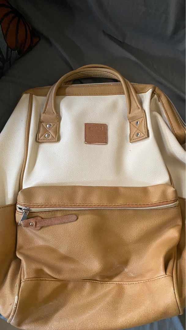 anello Two-Tone Faux Leather Backpack (Category: Backpacks) located in San Isidro. Submitted by miradelacruz1612 (Listing ID 1469963278, Image 1). Description: - Color: Stylish tan and cream combination - Material: Premium faux leather - Design: Wide-opening main compartment with a structured frame - Storage: Convenient front zipper pocket with pull tab - Comfort: Dual top handles and adjustable back straps with breathable mesh backing - Branding