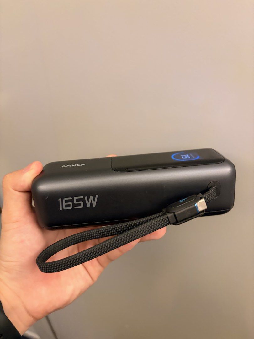 Anker smart power bank 165W (Category: Batteries & Power Banks) located in Makati City. Submitted by jaeclee0 (Listing ID 1470048476, Image 2). Description: - Brand/Model: Anker Smart Power Bank 165W - Capacity: 25000mAh / 90Wh - Color: Dark Grey - Features: Smart digital display showing output per port (C1, C2, C3, A) and battery temperature monitoring - Design: Sleek finish with built-in durable braided strap/cable - Condition: Excellent, well-