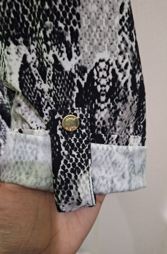 Anne klein snake skin pattern blouse medium - large zara mango T10 (Category: Blouses) located in San Pablo. Submitted by allyourbrandedneeds (Listing ID 1469969477, Image 3). Description: - Brand: Anne Klein - Design: Black & white snake print - Details: Gold-toned logo buttons, collar neckline - Sleeves: Three-quarter with roll-tab cuffs - Fit: Regular fit, standard length - Fabric: Lightweight, versatile for work or casual wear.