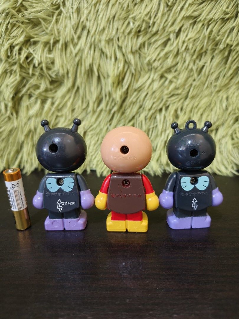Anpanman and Baikinman Figures Set (Category: Figurines & Statues) located in La Trinidad. Submitted by charlsensei (Listing ID 1469966960, Image 2). Description: - Set of 3 collectible anime figures - Includes 1 Anpanman (red/yellow outfit) and 2 Baikinman (1 standing, 1 sitting) - Stands approximately 3 inches tall each - Features stamped copyright text and screw attachments on the back.