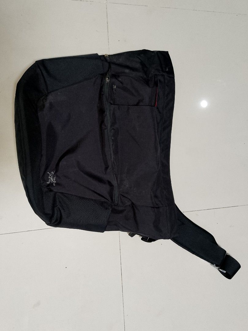 Arc'teryx Black Messenger Bag with Red Interior (Category: Sling Bags) located in Manila. Submitted by mjthrifted_second (Listing ID 1469974266, Image 1). Description: - Brand: Arc'teryx - Color: Sleek black exterior with a vibrant red interior lining - Storage: Multiple zip pockets and an exterior vertical zip pocket for easy organization - Strap: Adjustable strap with custom metal hardware featuring the Arc'teryx logo - Comfort: Padded back pan