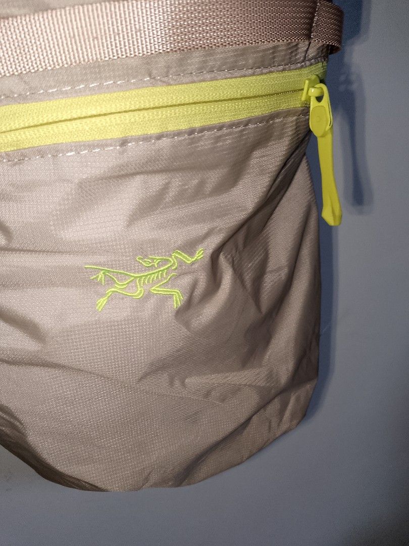 Arc'teryx Tan and Neon Yellow Backpack (Category: Backpacks) located in Manila. Submitted by mjthrifted_second (Listing ID 1469983262, Image 2). Description: - Brand: Arc'teryx - Color: Tan with vibrant neon yellow zippers - Branding: Embroidered logo on the front - Comfort: Breathable mesh shoulder straps - Features: Top grab handle and fully adjustable straps - Origin: Made in Vietnam - Condition: Excellent / Ready to use.