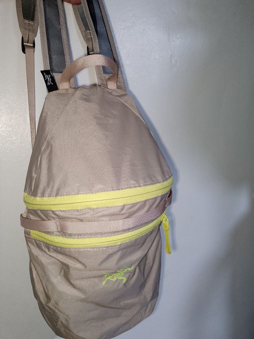 Arc'teryx Tan and Neon Yellow Backpack (Category: Backpacks) located in Manila. Submitted by mjthrifted_second (Listing ID 1469983262, Image 1). Description: - Brand: Arc'teryx - Color: Tan with vibrant neon yellow zippers - Branding: Embroidered logo on the front - Comfort: Breathable mesh shoulder straps - Features: Top grab handle and fully adjustable straps - Origin: Made in Vietnam - Condition: Excellent / Ready to use.