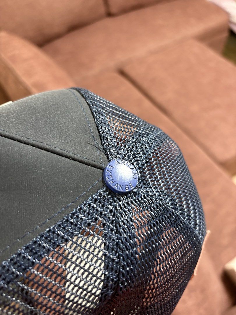 Armani Exchange Trucker Cap Blue A|X Logo Snapback Hat (Category: Caps & Hats) located in Manila. Submitted by breezy09breezy (Listing ID 1469990044, Image 2). Description: - Brand: Armani Exchange - Color: Dark Navy Blue with bold raised white A|X logo - Style: Classic trucker cap with breathable mesh back panels - Fit: Adjustable plastic snapback closure for a customized fit - Details: Features a brown leather logo patch above the back strap an