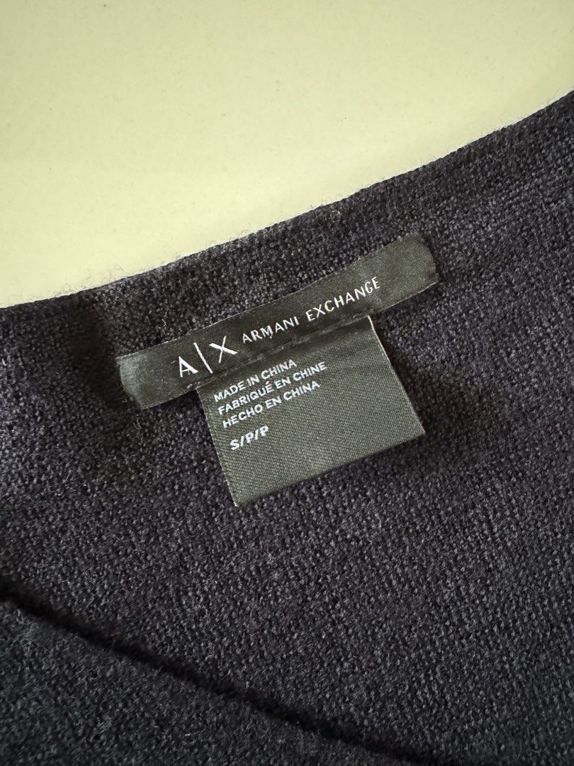 Armani Exchange V-neck Sweater Colorblock (Category: Longsleeves) located in Bulacan. Submitted by _arislmt (Listing ID 1470001054, Image 3). Description: Armani Exchange knit sweater in size small. Colorblock design with dark blue, black, and grey tones. V-neck cut with long sheer sleeves and signature metal brand plaque near the cuff. Made in China. Comfortable relaxed fit, great layering piece for cooler weather..