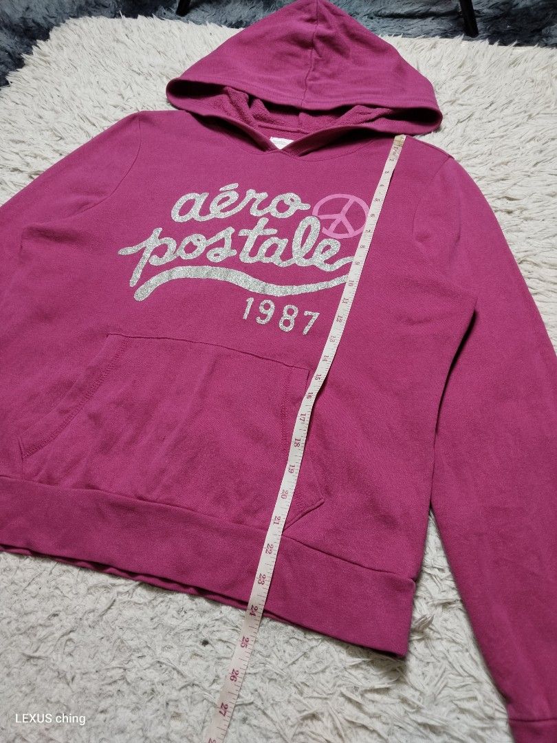 Aéropostale pullover hoodie a silver glitter script logo on chest. (Category: Coats, Jackets and Outerwear) located in Manila. Submitted by lexusthrift1995 (Listing ID 1469956613, Image 3). Description: Size- XL on tag but fit to LARGE Dimension- 20x24 Color rate- 9/10 Condition- 9/10 issue- small pinhole on pocket see last picture good condition ‼️400.pesos plus shipping fee 💸MODE OF PAYMENT- GCASH payment first 🚛MODE OF DELIVERY- J&T or LALAM