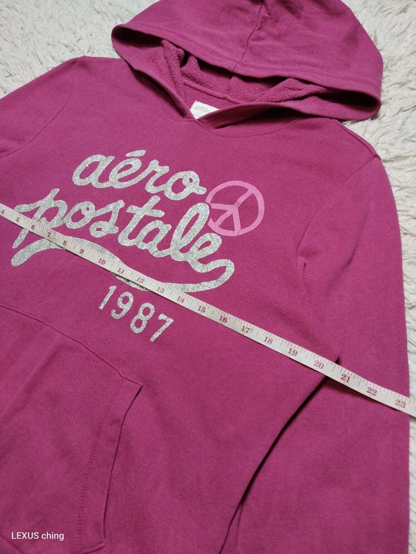 Aéropostale pullover hoodie a silver glitter script logo on chest. (Category: Coats, Jackets and Outerwear) located in Manila. Submitted by lexusthrift1995 (Listing ID 1469956613, Image 2). Description: Size- XL on tag but fit to LARGE Dimension- 20x24 Color rate- 9/10 Condition- 9/10 issue- small pinhole on pocket see last picture good condition ‼️400.pesos plus shipping fee 💸MODE OF PAYMENT- GCASH payment first 🚛MODE OF DELIVERY- J&T or LALAM